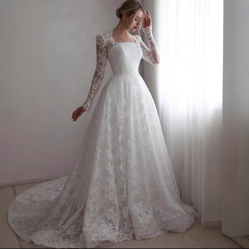 Vestido de novia de manga larga bordado con cola