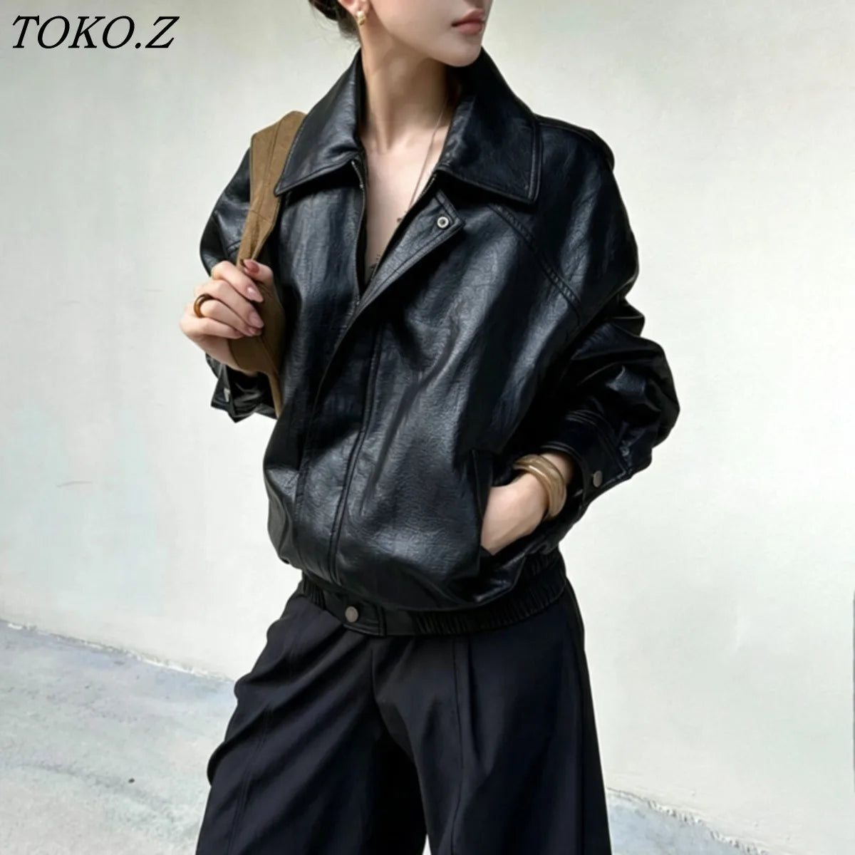 TOKO 2026 New Women Lapel Faux Leather Bomber Jacket Elastic Hem Zip Button Loose Long Sleeve Side Pocket Outerwear Coat