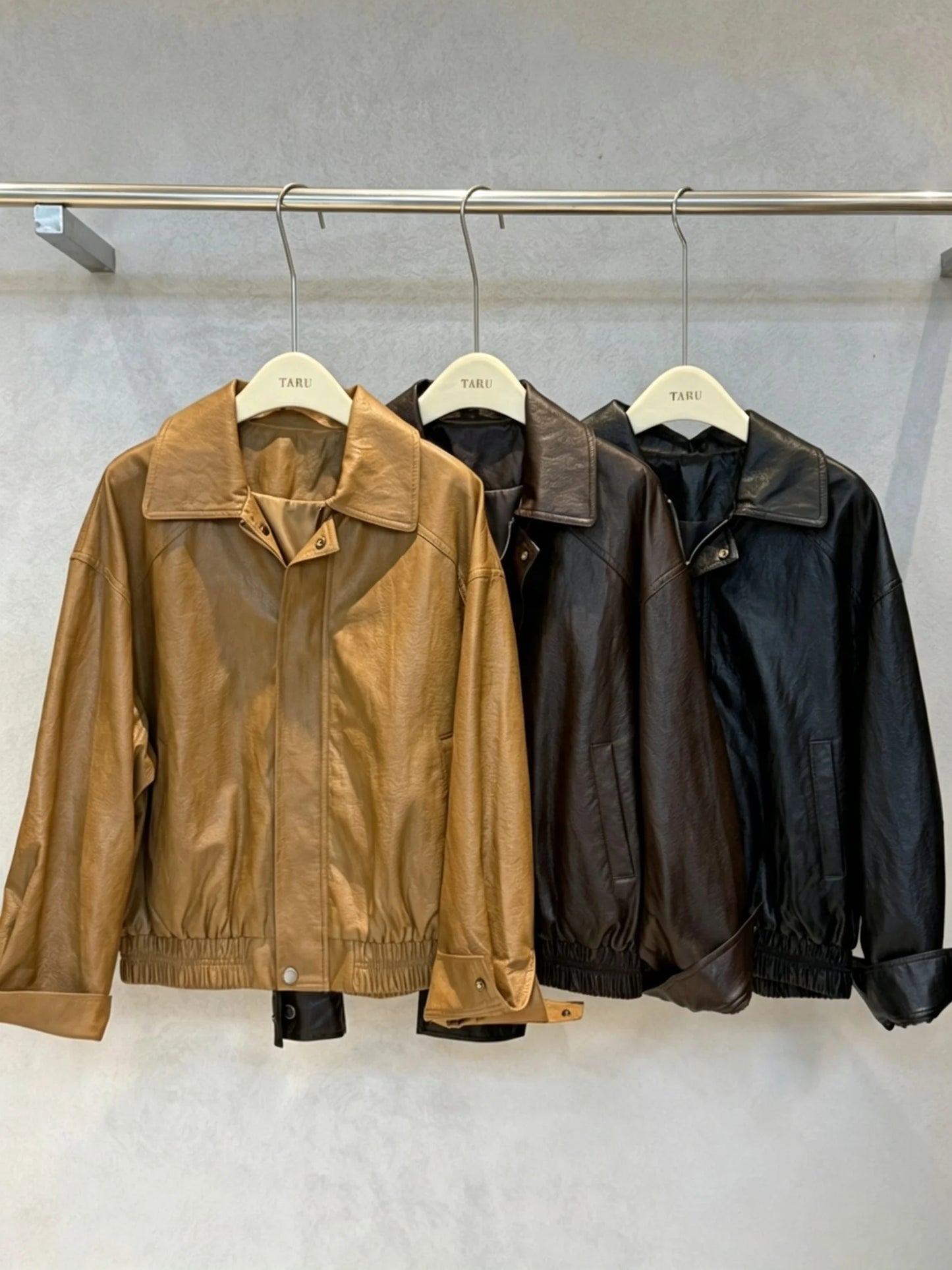 TOKO 2026 New Women Lapel Faux Leather Bomber Jacket Elastic Hem Zip Button Loose Long Sleeve Side Pocket Outerwear Coat