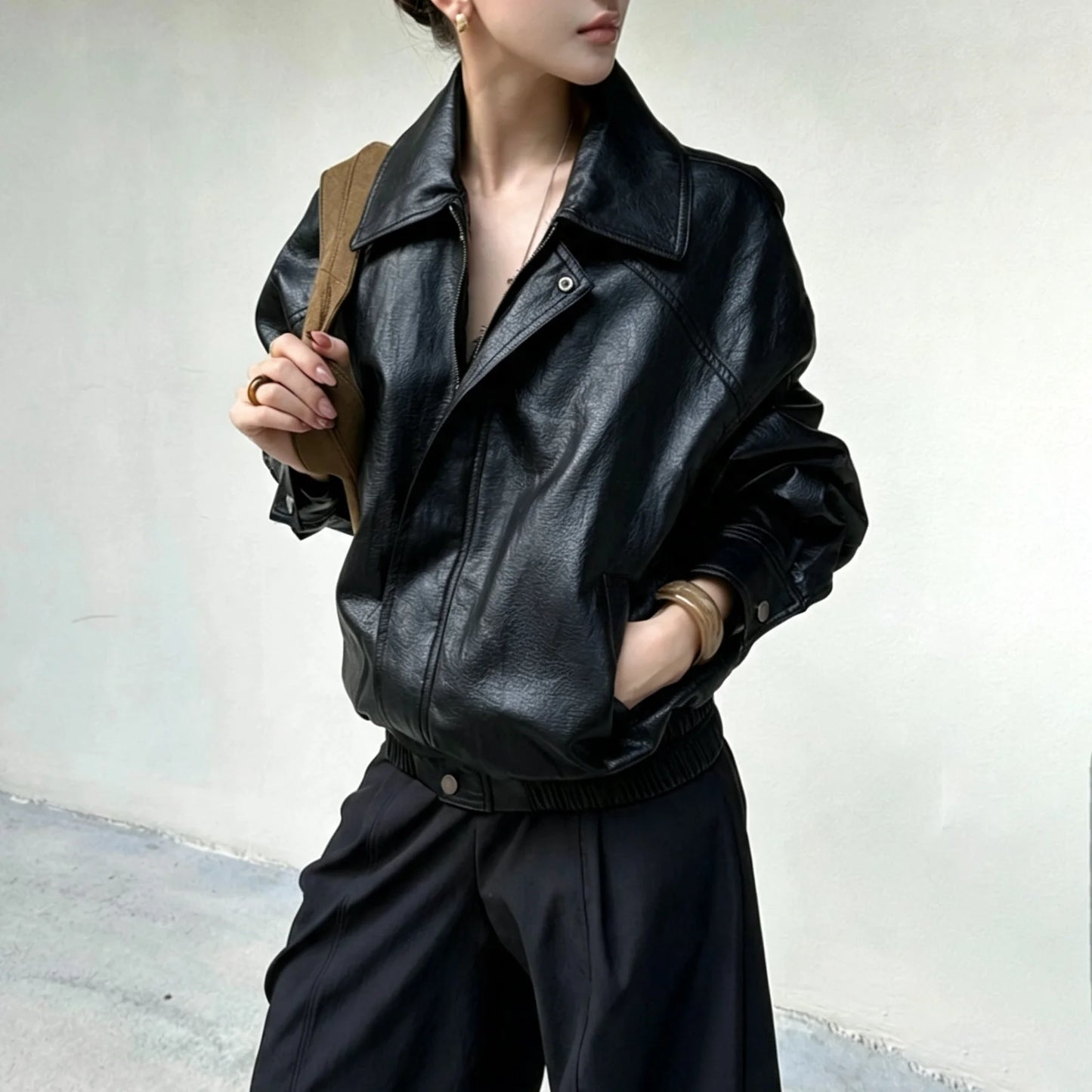 TOKO 2026 New Women Lapel Faux Leather Bomber Jacket Elastic Hem Zip Button Loose Long Sleeve Side Pocket Outerwear Coat