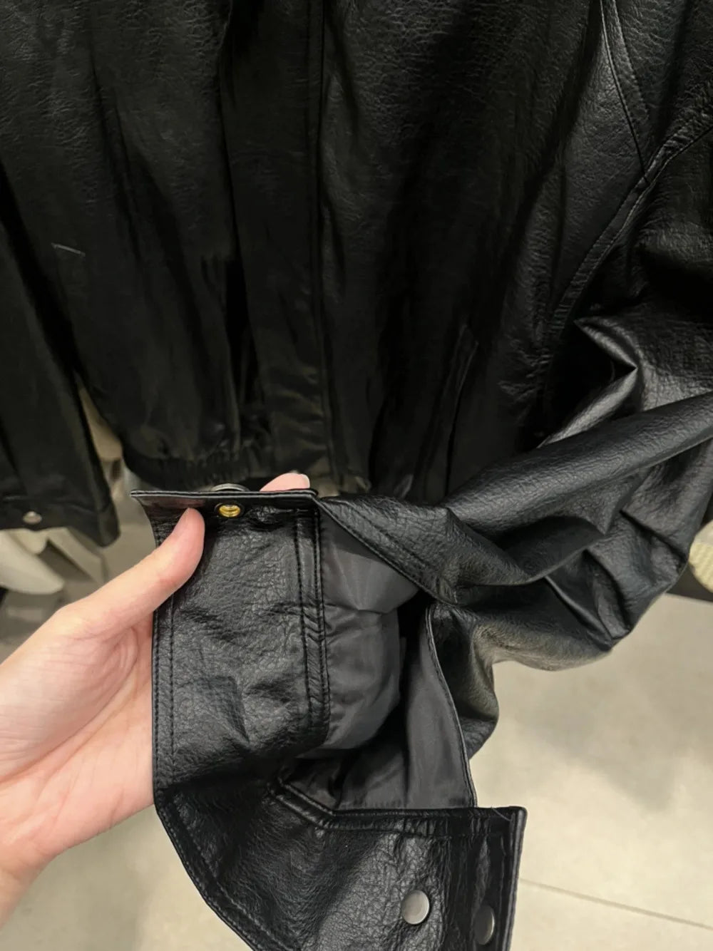 TOKO 2026 New Women Lapel Faux Leather Bomber Jacket Elastic Hem Zip Button Loose Long Sleeve Side Pocket Outerwear Coat