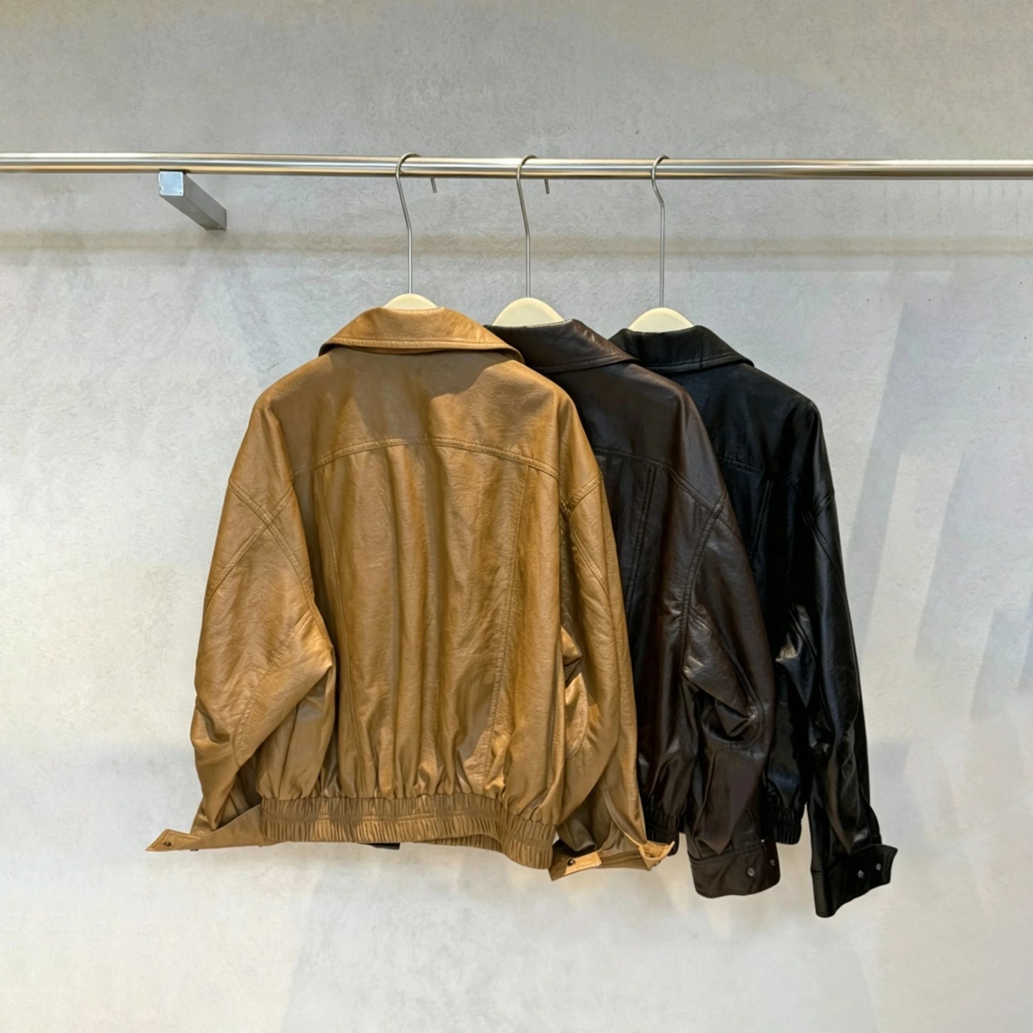 TOKO 2026 New Women Lapel Faux Leather Bomber Jacket Elastic Hem Zip Button Loose Long Sleeve Side Pocket Outerwear Coat