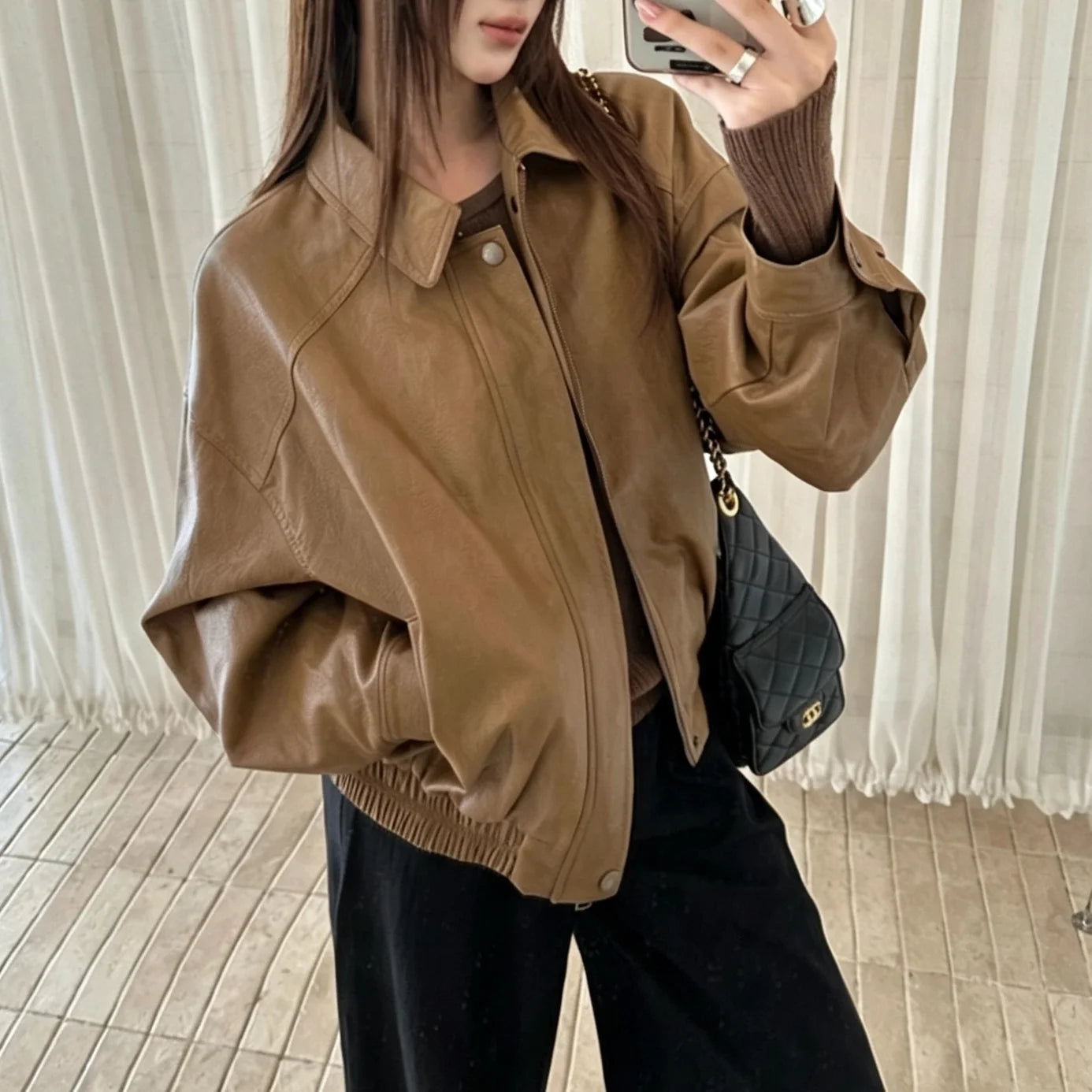 TOKO 2026 New Women Lapel Faux Leather Bomber Jacket Elastic Hem Zip Button Loose Long Sleeve Side Pocket Outerwear Coat