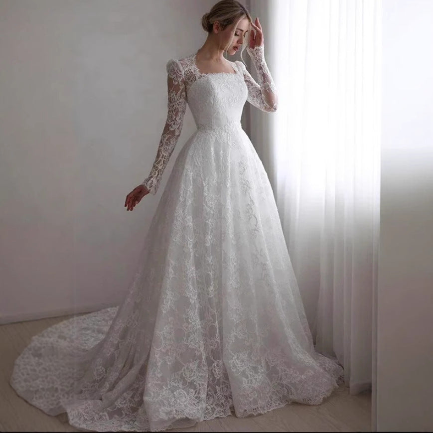 Vestido de novia de manga larga bordado con cola